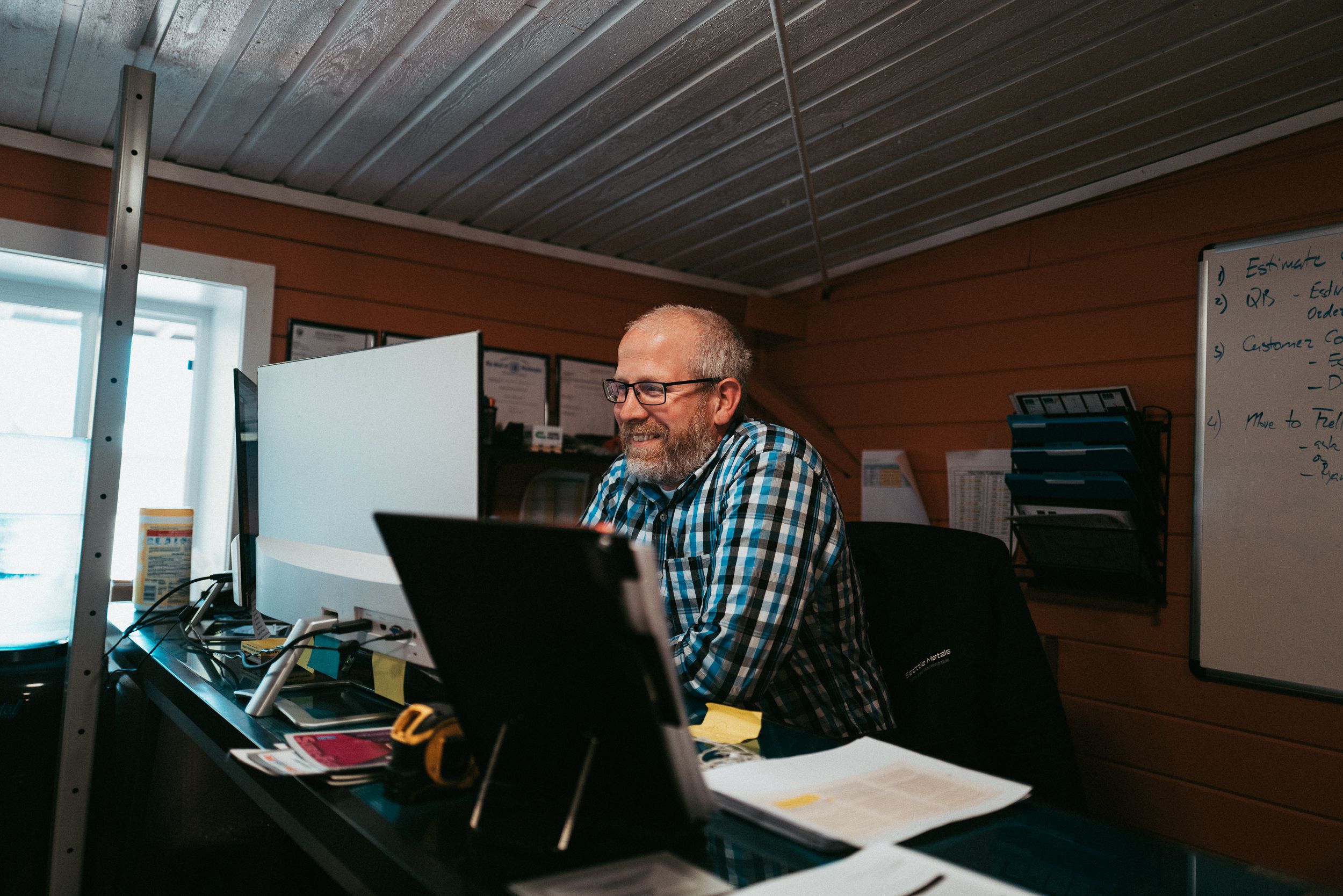 A Seattle Metals team member at a computer in the office