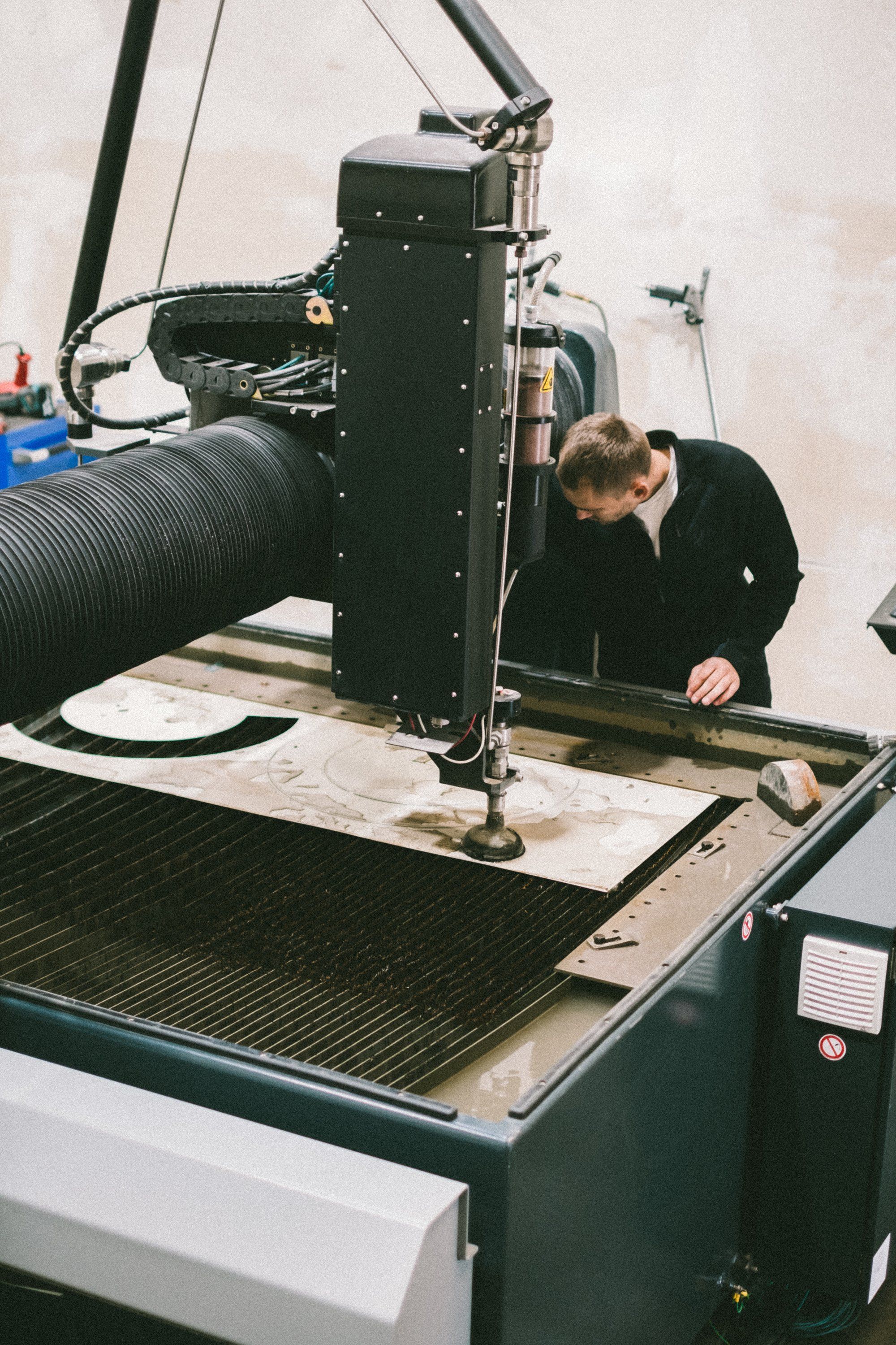 A waterjet cutting head over a metal plate